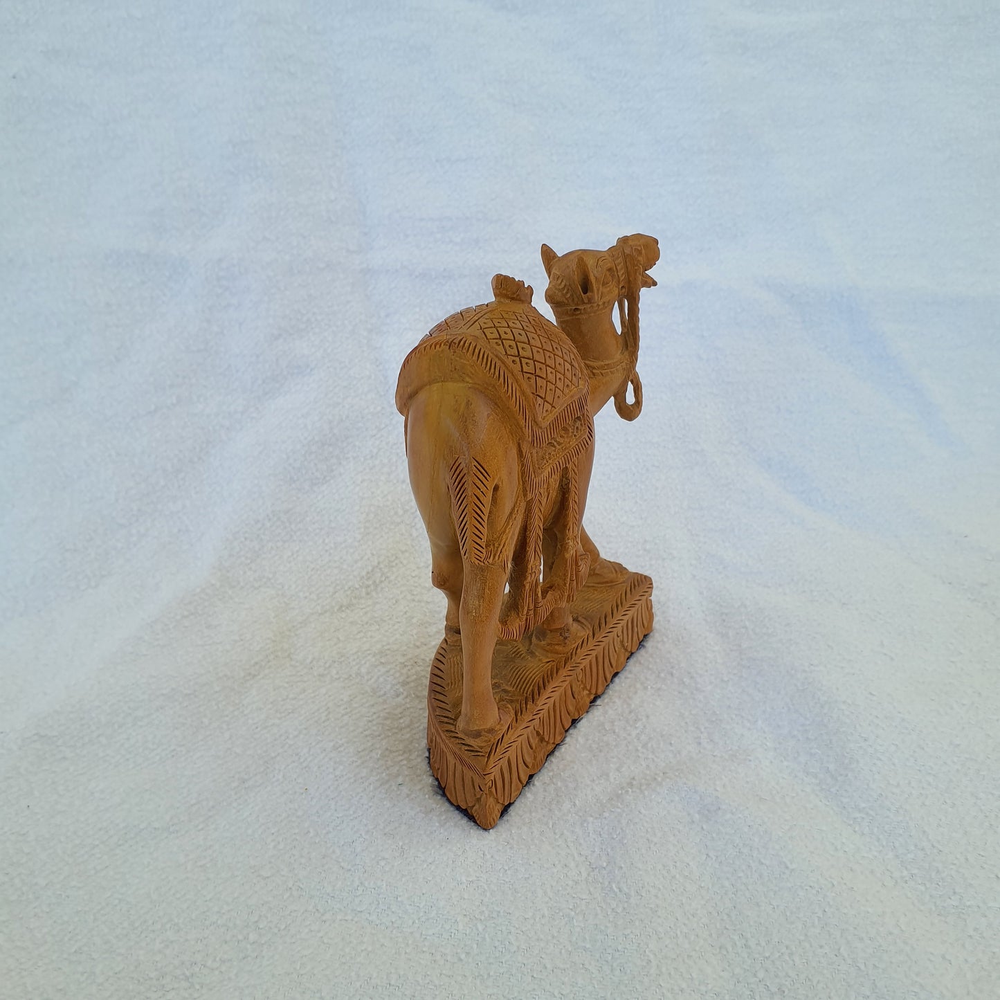 Sandalwood camel: Intricately carved collector's item with artistic ornaments