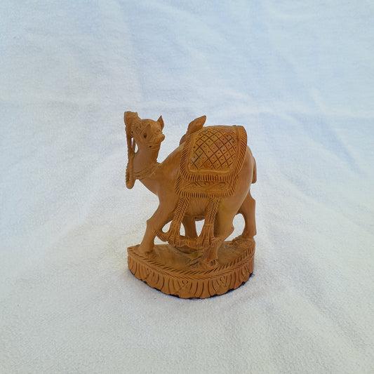 Sandalwood camel: Intricately carved collector's item with artistic ornaments