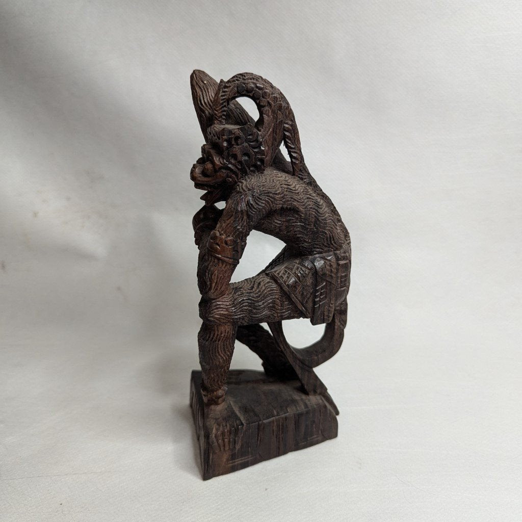Hanuman in battle: Ancient coromandel wood statue against the Naga serpent