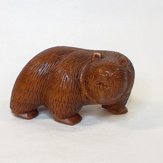 Hand-carved grizzly bear made of teak wood: A lifelike, unique piece.
