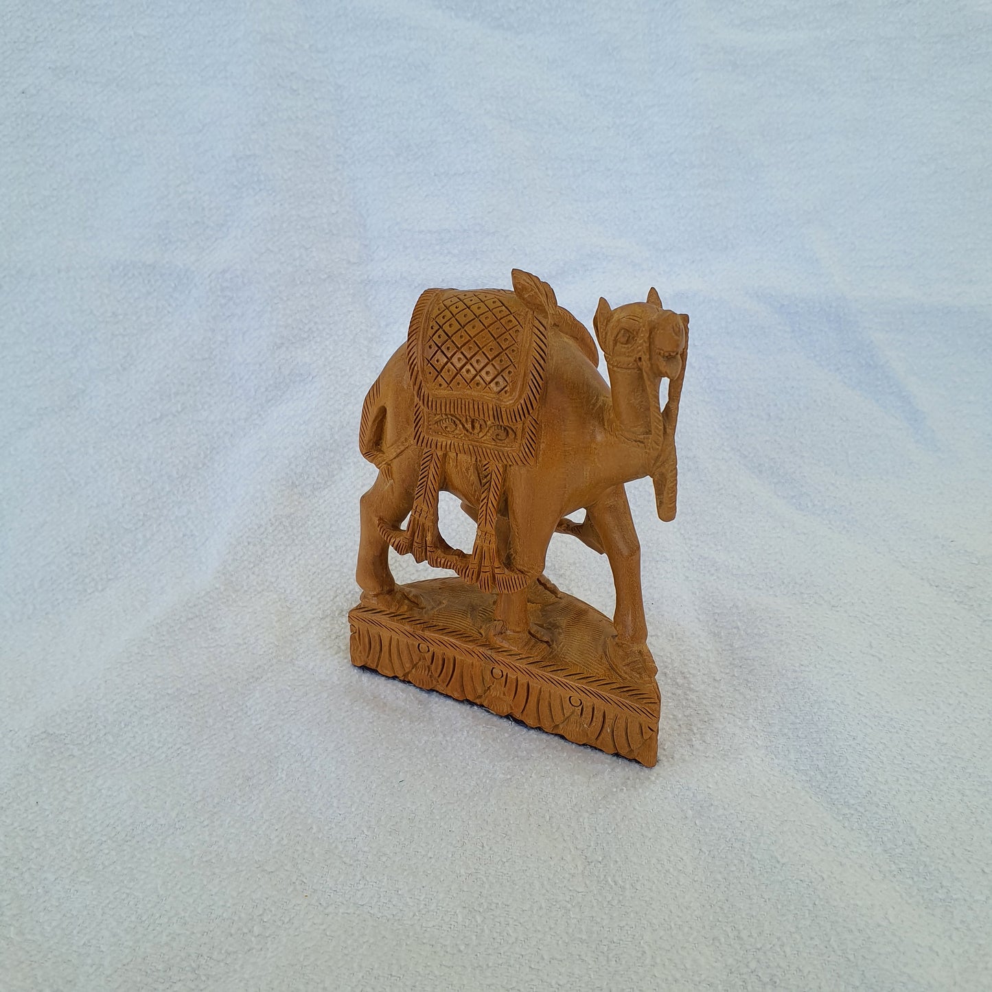 Sandalwood camel: Intricately carved collector's item with artistic ornaments