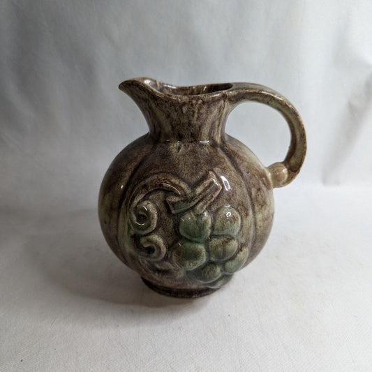 Ceramic wine jug with grape motif: Handcrafted elegance for connoisseurs